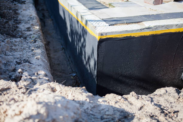 Professional Basement Waterproofing technician working in Woodstock, GA
